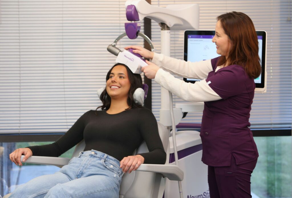Patient relaxing during NeuroStar TMS treatment with a clinician